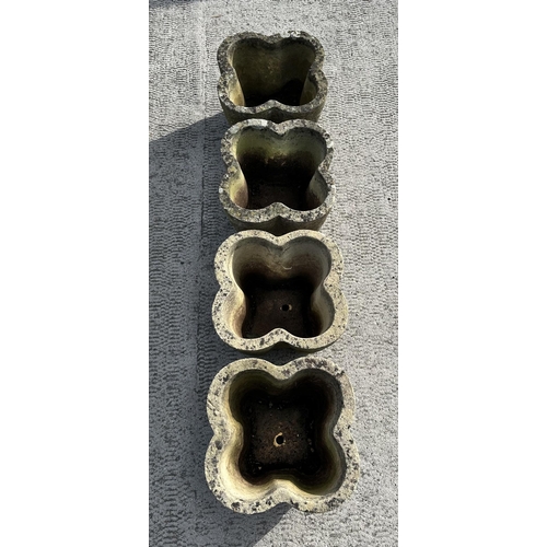 62 - A set of four well weathered reconstituted stone lobed form planters, 32cms wide; together with a te... 