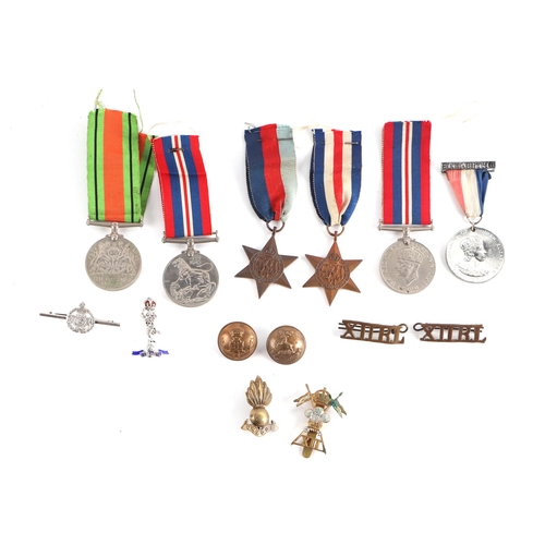 92 - A quantity of assorted militaria to include a Defence medal 39-45 Star, French & German Star, Corona... 