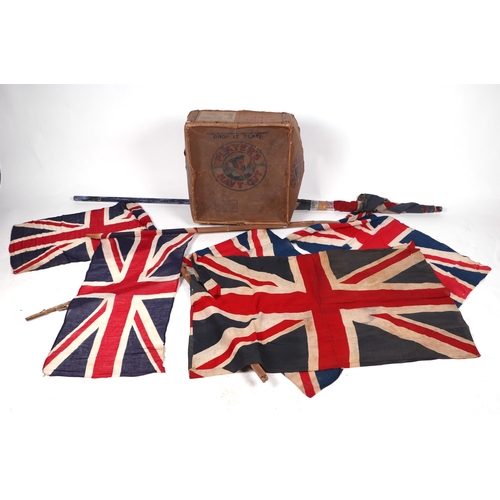 115 - A vintage Union Jack flag, 105 by 65cm; together with four other Union Jack flags on poles; together... 