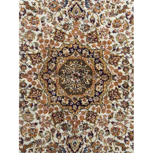 124 - A silk and cotton rug, the central medallion within a multi floral border, 170 by 123cms.