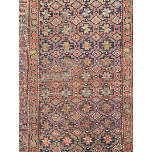 128 - A Persian rug with repeating geometric pattern in a multi border, on a brown ground, 170 by 95cms.