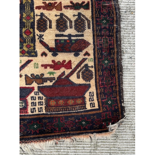 131 - A Persian Afghan war rug with repeating motifs, on a blue and cream ground within a multi border, 10... 