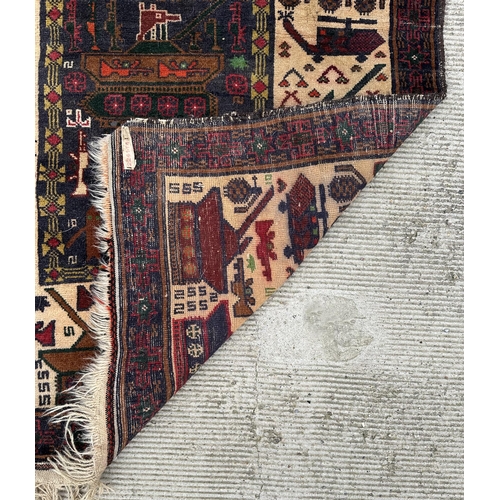 131 - A Persian Afghan war rug with repeating motifs, on a blue and cream ground within a multi border, 10... 