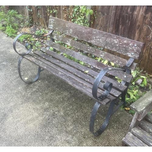 14 - A garden bench with wrought iron scroll arms and slatted wooden seat, 121cms wide.