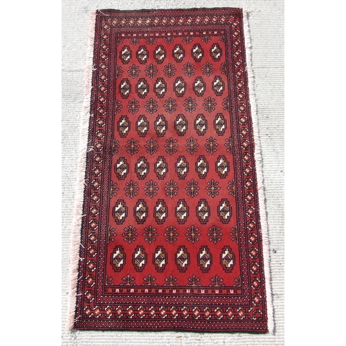 144 - Two small Persian Turkoman woollen hand-made rugs with geometric designs on a red ground, each appro... 