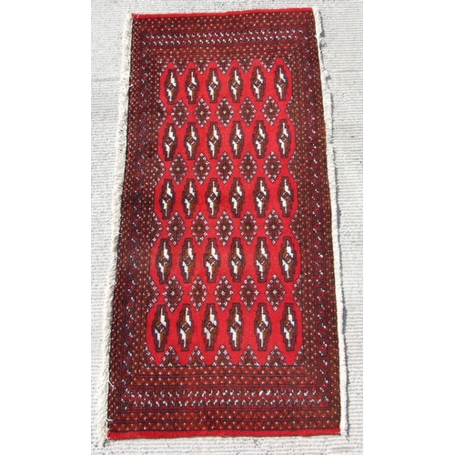 144 - Two small Persian Turkoman woollen hand-made rugs with geometric designs on a red ground, each appro... 