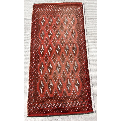 145 - Two small Persian Turkoman woollen hand-made rugs with geometric designs on a red ground, each appro... 