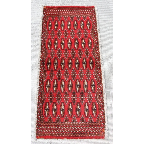 146 - Two small Persian Turkoman woollen hand-made rugs with geometric designs on a red ground, each appro... 