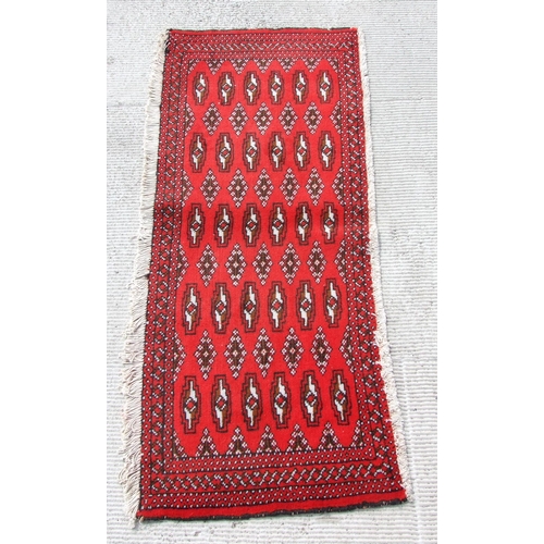 147 - Two small Persian Turkoman woollen hand-made rugs with geometric designs on a red ground, each appro... 