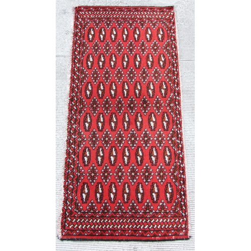 149 - Two small Persian Turkoman woollen hand-made rugs with geometric designs on a red ground, each appro... 