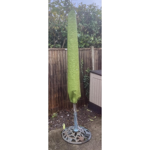 16 - A large garden parasol on a cast stand.