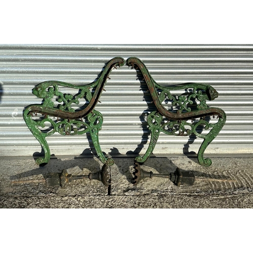 19 - A pair of Coalbrookdale style cast iron bench ends with lion mask scroll arms; together with a pair ... 