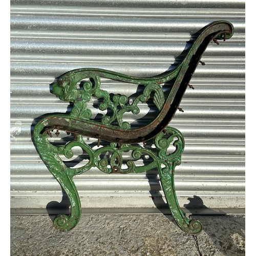 19 - A pair of Coalbrookdale style cast iron bench ends with lion mask scroll arms; together with a pair ... 