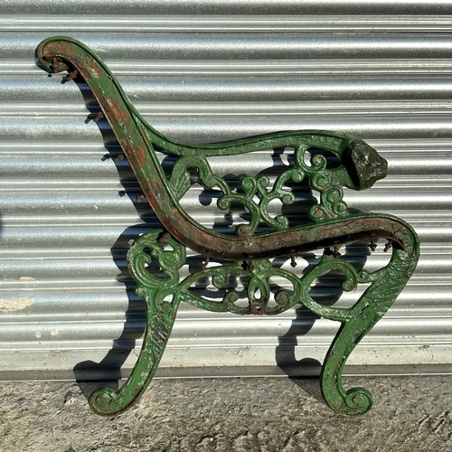 19 - A pair of Coalbrookdale style cast iron bench ends with lion mask scroll arms; together with a pair ... 