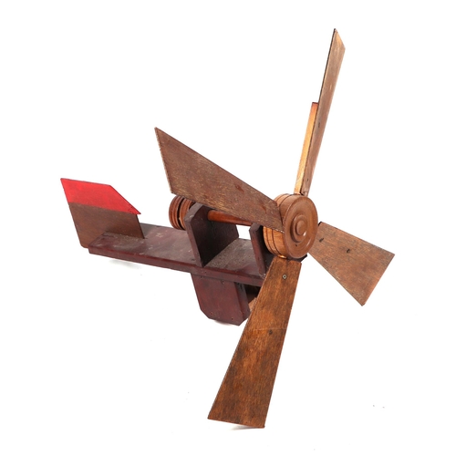 20 - A scratch built wooden windmill weather vane, 63cms long.