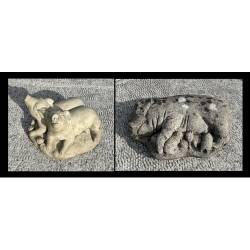 22 - A reconstituted stone recumbent pig and piglets, 50cms wide; together with another similar garden st... 