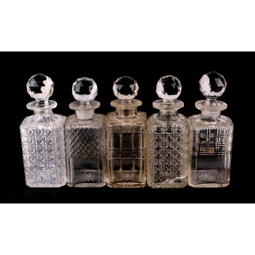 233 - A quantity of cut glass decanters to include a set of five liquor decanters.