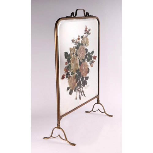 24 - A brass fire screen with mirrored plate decorated with a spray of roses, 49cms wide.