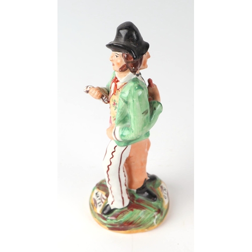 248 - A Staffordshire back-to-back figure depicting a gentleman drinking gin and water, 22cms high.