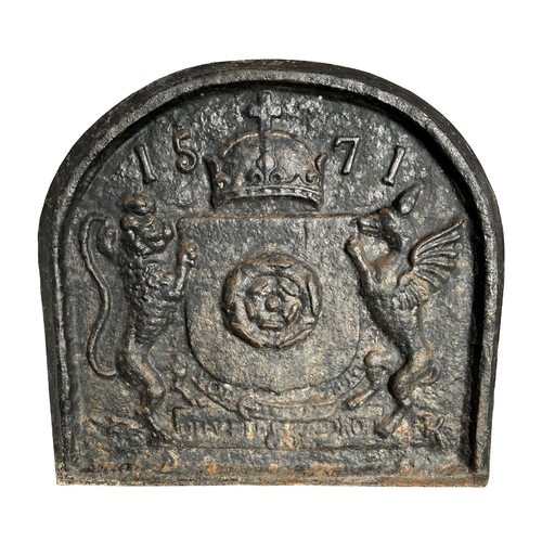 25 - A cast iron fire back with heraldic crest and dated 1571, 71cms wide.