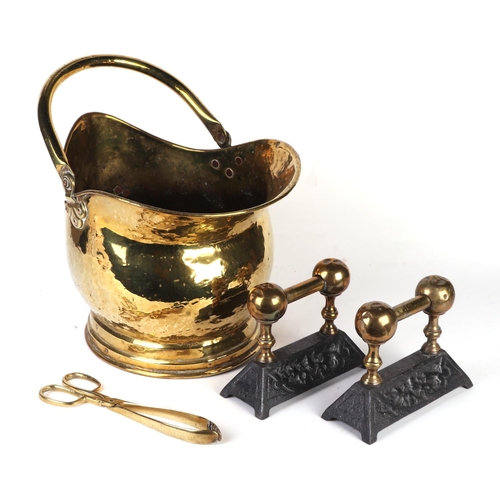 27 - A pair of steel and brass fire dogs; together with a brass coal scuttle; fire irons and copper kettl... 