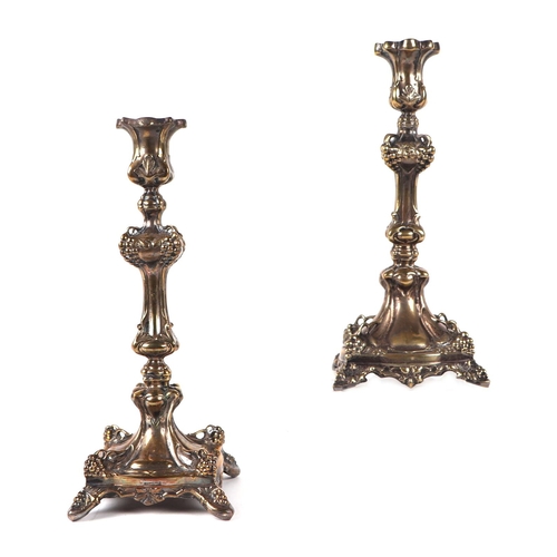 438 - A pair of French silver plated candlesticks, 24cms high.