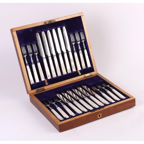 439 - A boxed set of silver plated dessert knives and forks with mother of pearl handles.