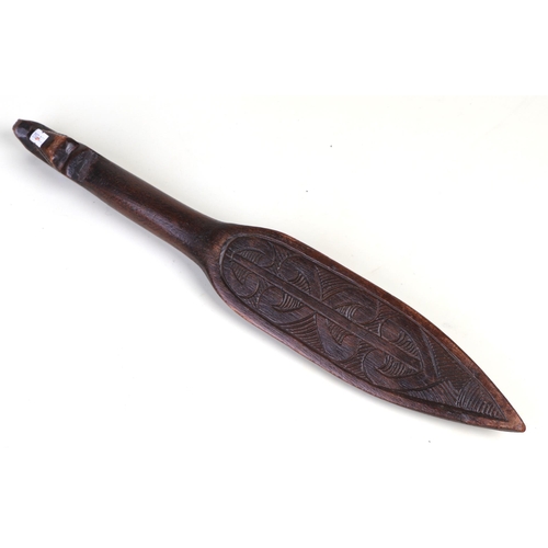 44 - A Maori carved wooden dance paddle with Tiki inlay decoration, 48cms long.