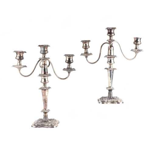 446 - A pair of silver plated rococo style three-branch candelabra, 40cms high (2).