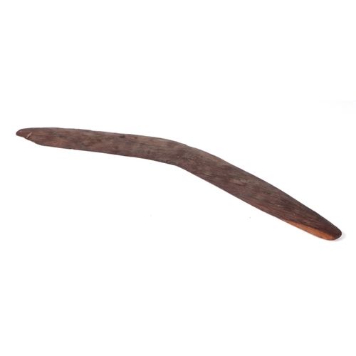 47 - An Australian Aboriginal chip carved boomerang, 60cms wide.