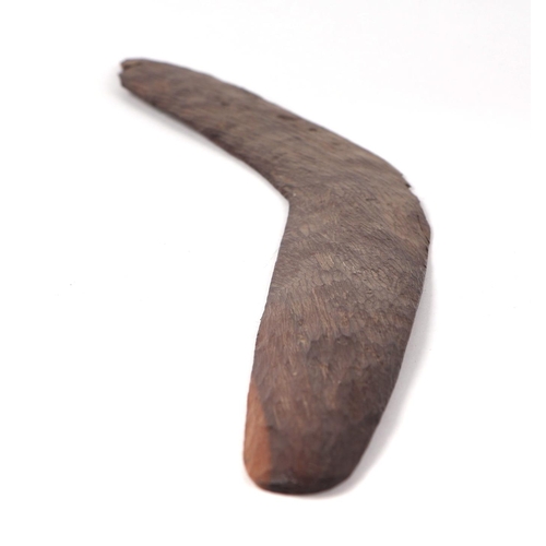 47 - An Australian Aboriginal chip carved boomerang, 60cms wide.