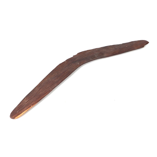 47 - An Australian Aboriginal chip carved boomerang, 60cms wide.