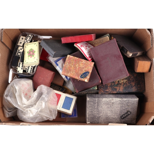 67 - A quantity of vintage playing cards, cribbage boards, dominoes and similar items.