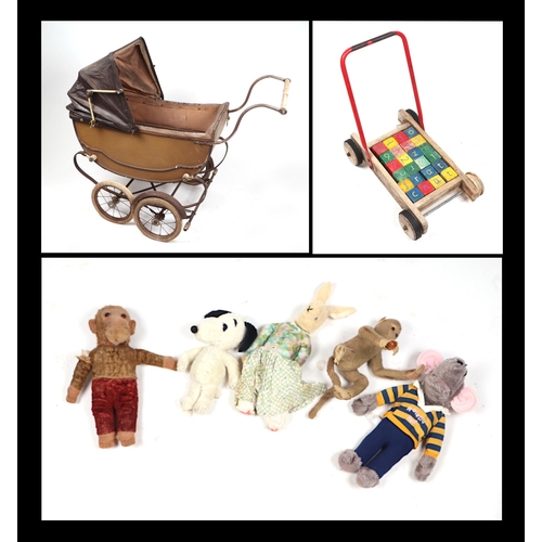 71 - A Victorian style pram containing various plush toys and teddy bears; together with a push-along tro... 