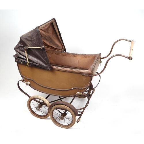 71 - A Victorian style pram containing various plush toys and teddy bears; together with a push-along tro... 