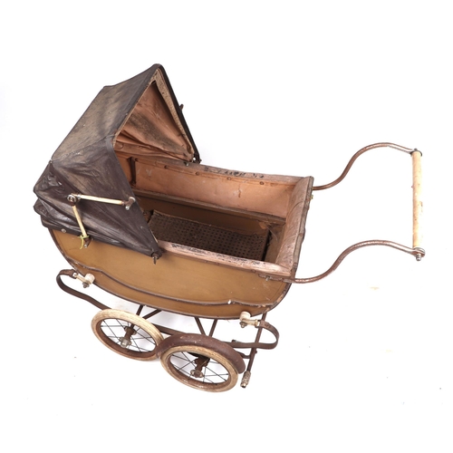 71 - A Victorian style pram containing various plush toys and teddy bears; together with a push-along tro... 