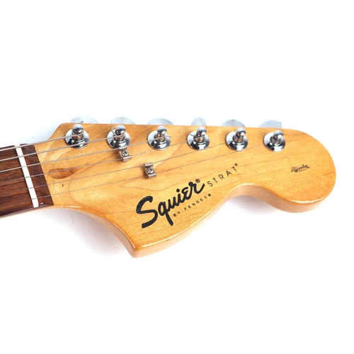 75 - A Squire Stratocaster by Fender Electric Guitar, in a soft carry case.