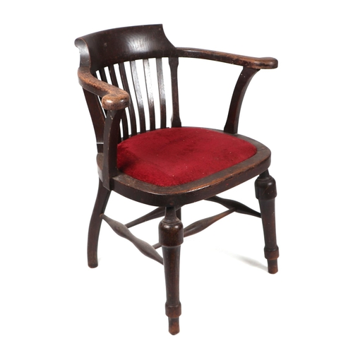 752 - A Smoker's bow armchair with padded seat and turned front legs.