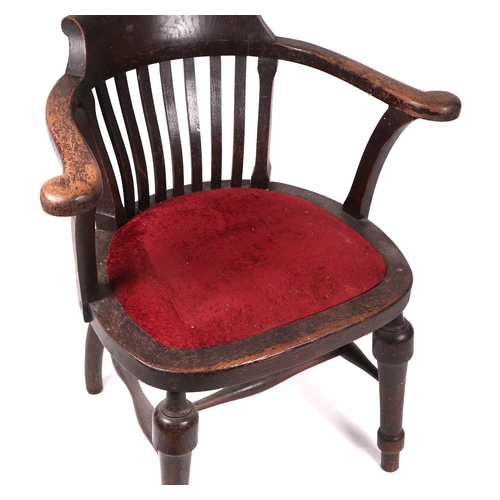 752 - A Smoker's bow armchair with padded seat and turned front legs.