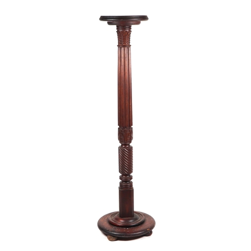 841 - A Victorian carved oak torchere with fluted column and stepped circular base, 142cms high.
