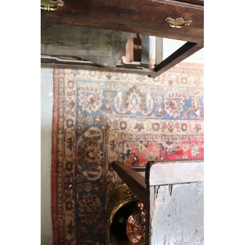 121 - A large Persian hand knotted woollen rug decorated with foliate scrolls, on a red ground, 310 by 330... 