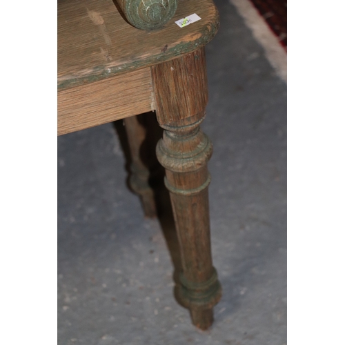 760 - A Victorian oak window seat with tapering reeded and turned legs, with traces of green painted decor... 