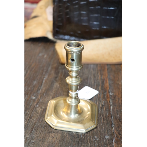 291 - An early brass candlestick, 14cms high.