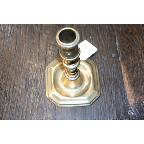 291 - An early brass candlestick, 14cms high.