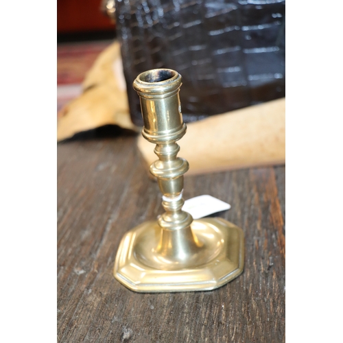 291 - An early brass candlestick, 14cms high.