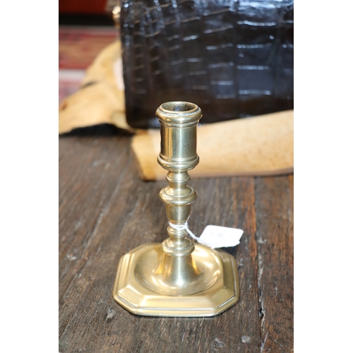 291 - An early brass candlestick, 14cms high.