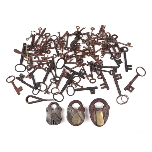 1001 - A large quantity of antique steel keys; together with three padlocks.