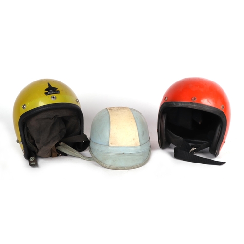 1023 - A Waddington's Topper Corker vintage crash helmet with leather neck strap and neck protection togeth... 