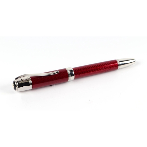 1034 - A red guilloche enamel fountain pen with iridium point nib, 15cms long.