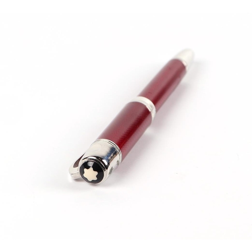 1034 - A red guilloche enamel fountain pen with iridium point nib, 15cms long.